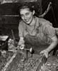 Ethel Williams assembles jacks at Auto Specialties for use in army trucks, ca. 1939 - 1942