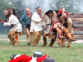 Natives carry the body of Tecumseh off of the battlefield