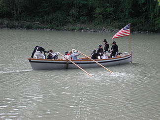 Re-enactors in boat on river