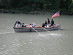 Re-enactors in boat on river